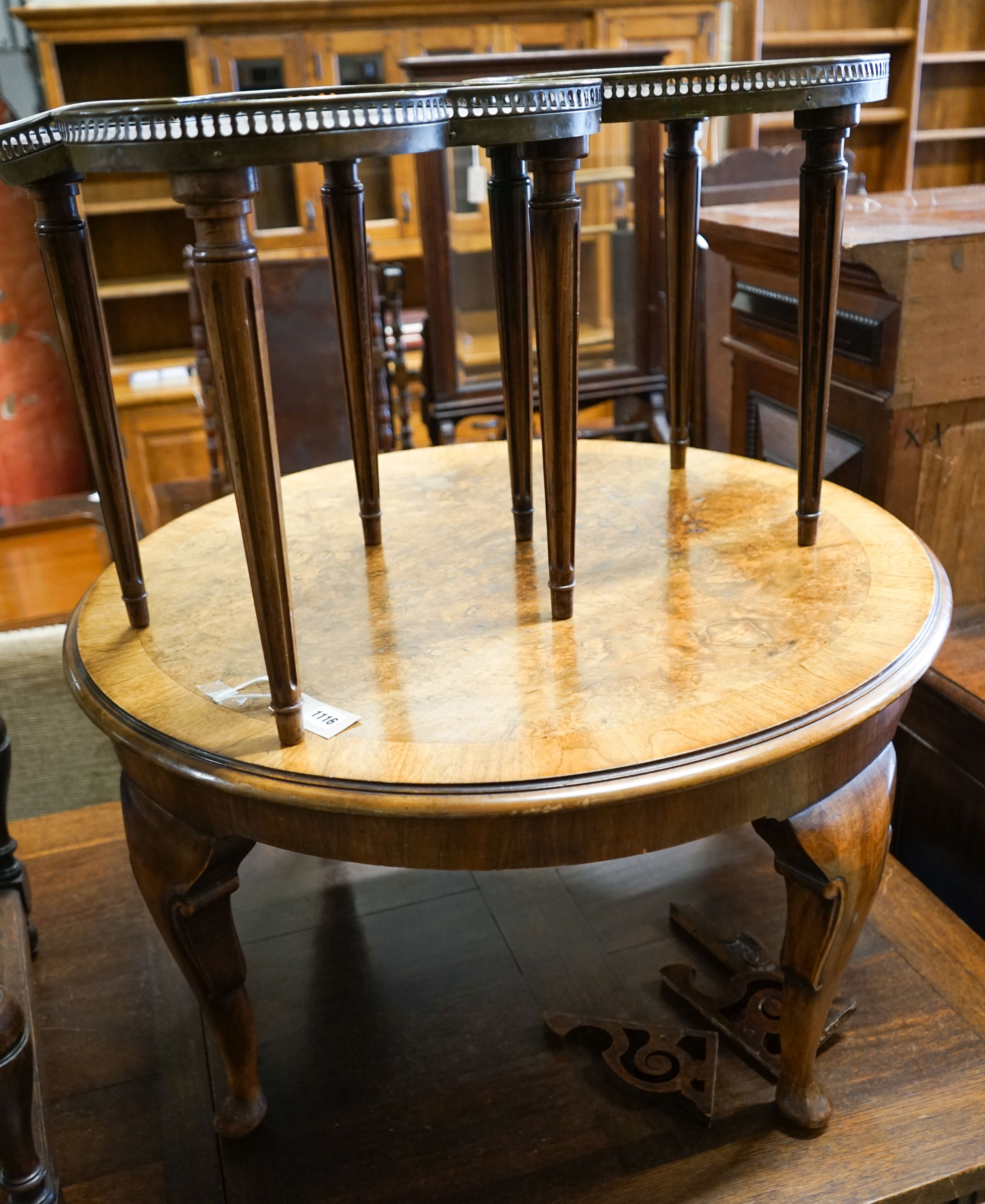 A circular burr walnut cabriole leg coffee table, diameter 84cm, height 47cm together with two Continental mahogany side tables with fretted brass galleries